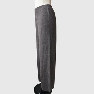 May include: Grey wide-leg knit trousers with a straight leg and a slightly cropped length.