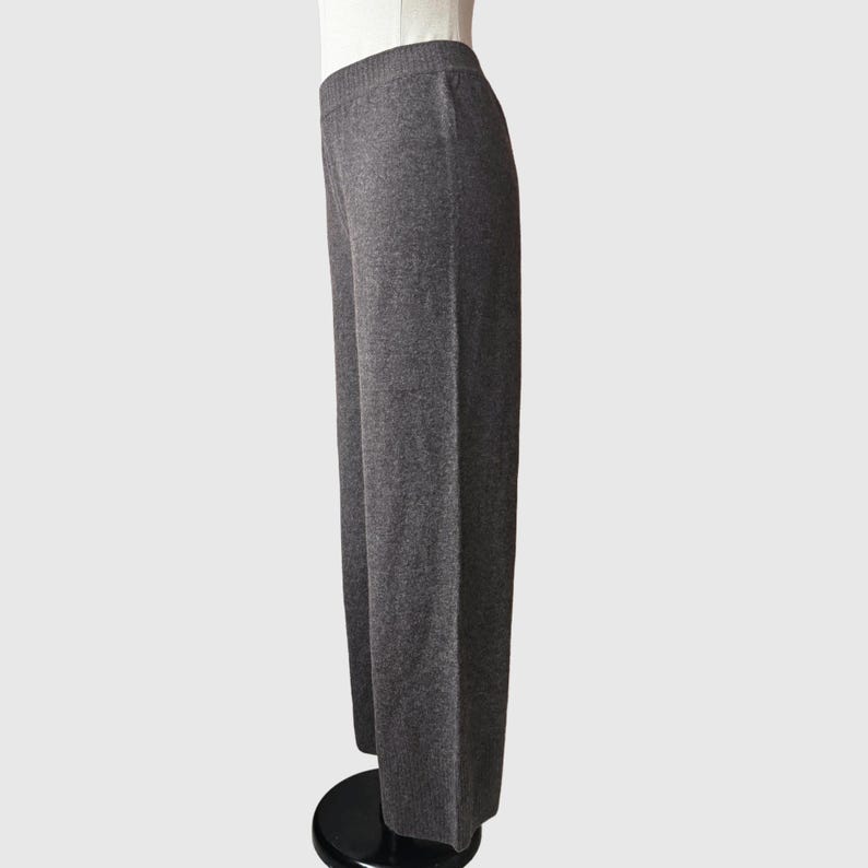 May include: Grey wide-leg knit trousers with a straight leg and a slightly cropped length.