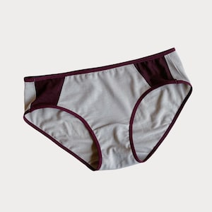 May include: Gray underwear with a burgundy trim and a burgundy panel on the side.
