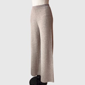 May include: Grey wide-leg knit trousers with a ribbed texture.