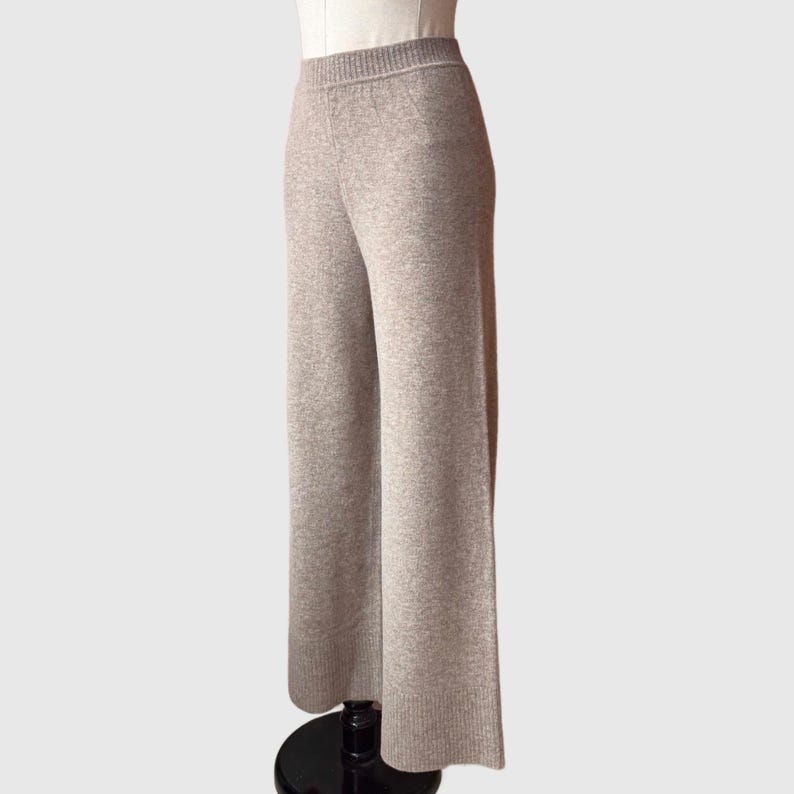 May include: Grey wide-leg knit trousers with a ribbed texture.