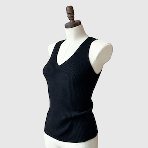 May include: A black ribbed sleeveless knit top with a v-neck.