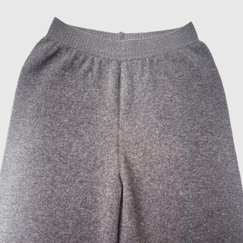 May include: Grey sweatpants with a ribbed waistband.