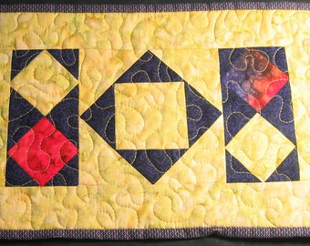 Yellow, purple and red batik diamonds placemat