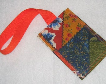 Crazy quilt luggage tag with orange strap