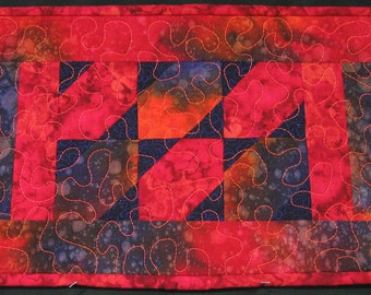 Orange, purple and red batik triangles placemat