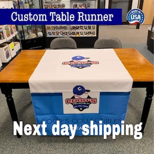 Custom Table Runner A table runner with a baseball cap design, labeled "Custom Table Runner" and "COP's COLLECTibles", is displayed in a room with shelves of collectibles in the background.
