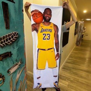 Custom Body Pillowcase a man holding a towel with a picture of a basketball player on it