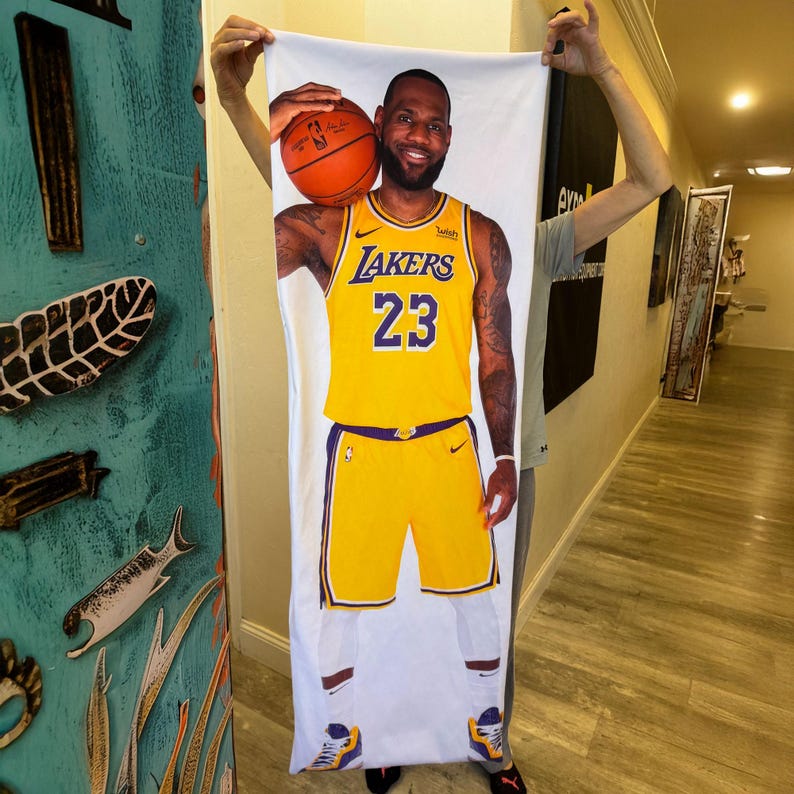 Custom Body Pillowcase a man holding a towel with a picture of a basketball player on it