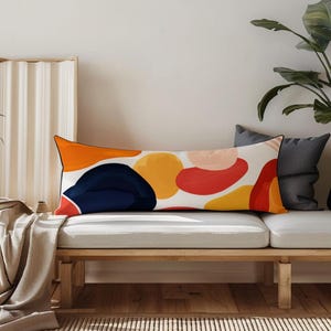 Custom Body Pillowcase a white couch with a colorful pillow on top of it