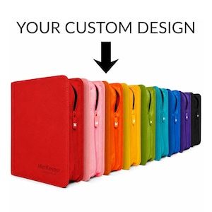 May include: A row of zippered storage binders in a spectrum of colors including red, pink, orange, yellow, green, teal, blue, purple, and black. The text YOUR CUSTOM DESIGN appears at the top with a black arrow pointing to the binders.