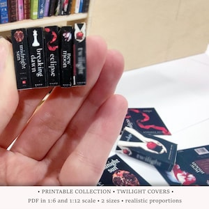 May include: A set of six miniature Twilight book covers, featuring the titles "Midnight Sun", "Breaking Dawn", "Eclipse", "New Moon", and "Twilight". The covers are printed in black and white with red accents.