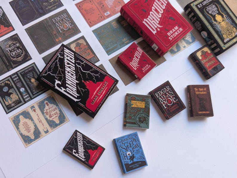 May include: A collection of miniature books featuring classic literature titles. The books have various colors and designs, including red, black, and blue covers. Titles include "Frankenstein," "Dracula," and "The Legend of Sleepy Hollow."