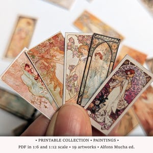May include: Miniature art prints with Art Nouveau designs. The prints display detailed illustrations of women, flowers, and decorative borders in pastel shades. The image text reads: "PRINTABLE COLLECTION • PAINTINGS. PDF in 1:6 and 1:12 scale • 19 artworks • Alfons Mucha ed."
