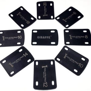 May include: Eight black rectangular plastic pieces with rounded corners and a silver inscription. Each piece has a different number from 6 to 20, with the text "FDG-STR-PAS" before the number. One piece has the word "GIRAFFE" inscribed on it.