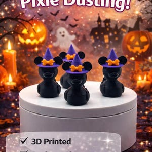 May include: A group of black duck figurines wearing purple witch hats with orange bows. The image has a Halloween theme with pumpkins, candles, and a full moon in the background. Text reads "Perfect for Pixie Dusting!" and "3D Printed, Perfect Gift, Cruise / Park Ready."