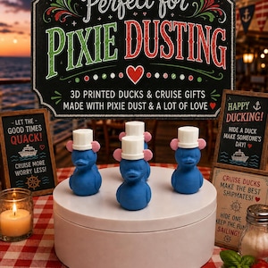 May include: Three blue 3D printed ducks with white top hats and pink ears on a white circular stand. A large sign reads Perfect for PIXIE DUSTING 3D PRINTED DUCKS & CRUISE GIFTS MADE WITH PIXIE DUST & A LOT OF LOVE. Smaller signs read LET THE GOOD TIMES QUACK and HAPPY DUCKING.