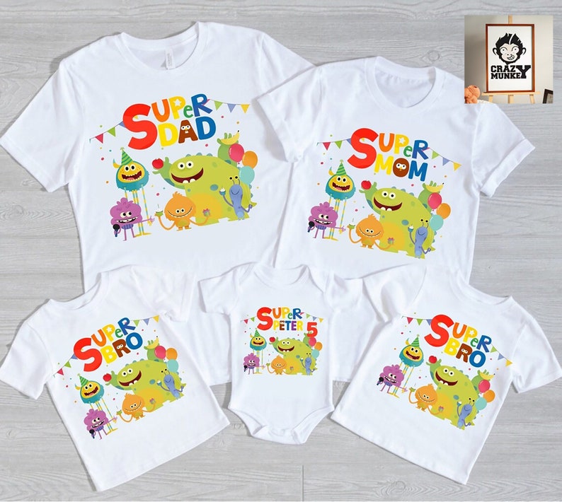 May include: Set of four white t-shirts with colorful graphics featuring cartoon monsters and the text "Super Dad", "Super Mom", "Super Bro", and "Super Peter 5".