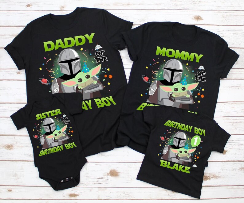 May include: Black t-shirts with a Star Wars theme, featuring the Mandalorian and Grogu. The shirts are labeled "Daddy", "Mommy", "Sister", and "Birthday Boy", with the name "Blake" on one. Festive birthday decorations are included.