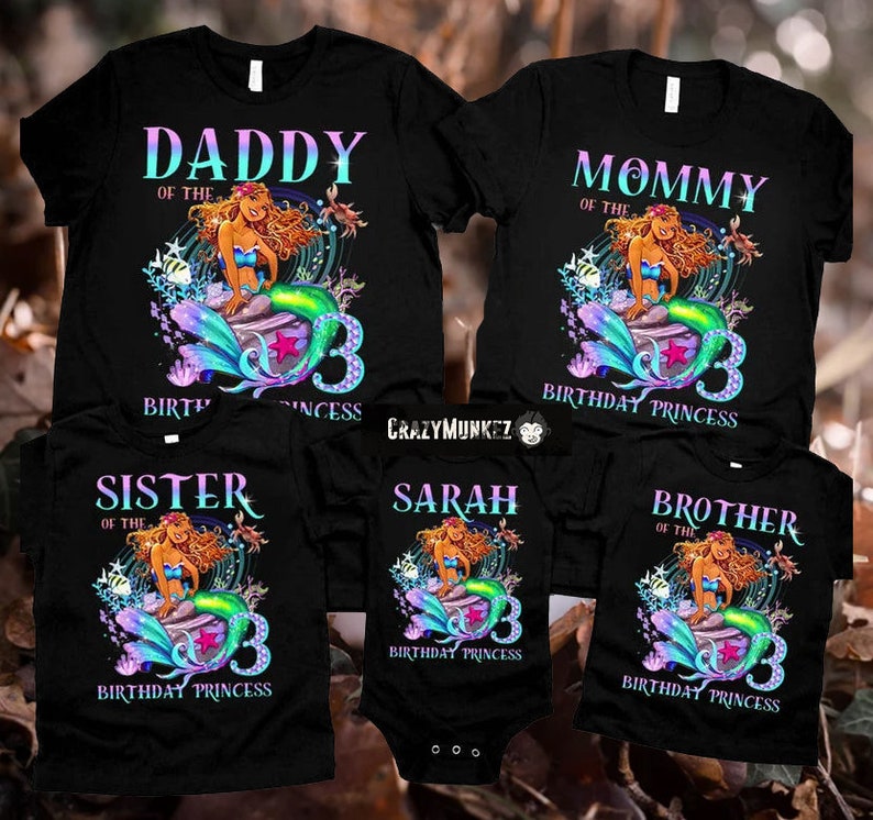 May include: A set of five black t-shirts with a mermaid graphic and the text "Daddy of the Birthday Princess", "Mommy of the Birthday Princess", "Sister of the Birthday Princess", "Sarah Birthday Princess", and "Brother of the Birthday Princess".