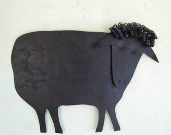 May include: Black metal sheep wall decoration with a curly wool design. The sheep is made of textured metal and has a rustic look.