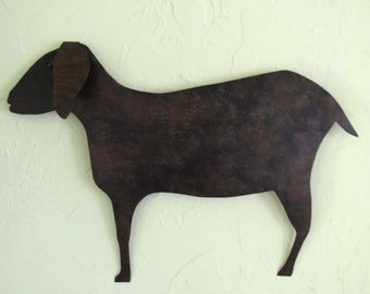 May include: A rustic metal silhouette of a goat, painted in a dark brown colour with a mottled finish. The goat is standing on a white background.