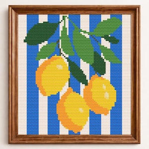 May include: A framed cross-stitch artwork depicting a lemon branch against a blue and white striped backdrop. The lemons are yellow and orange, with green leaves. The frame is wooden.