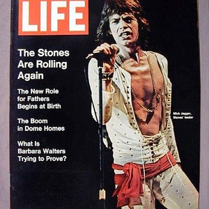 May include: LIFE magazine cover featuring Mick Jagger of The Rolling Stones. The cover has the text "The Stones Are Rolling Again" and other headlines. Jagger is wearing a white outfit with a red sash and gold jewelry.