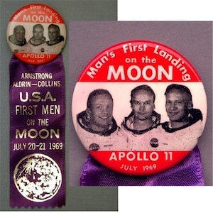 May include: A red and white button with a picture of the Apollo 11 astronauts and the text "Man's First Landing on the MOON APOLLO 11 JULY 1969". A purple ribbon with the text "ARMSTRONG ALDRIN-COLLINS U.S.A. FIRST MEN ON THE MOON JULY 20-21 1969" and a gold moon image.