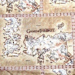 May include: A tan fabric featuring a repeating map print of the fictional world from Game of Thrones. The design includes detailed black line work for landmasses and coastlines, separated by decorative geometric borders in a darker brown tone.