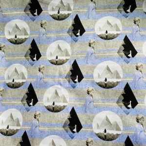 May include: A white fabric with a repeating pattern of a blue-clad figure standing in front of a geometric mountain range. The background is a light brown with blue stripes.