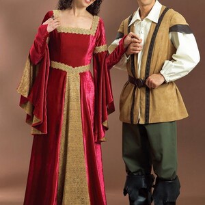 May include: A couple dressed in medieval costumes. The woman is wearing a red velvet gown with gold trim and a gold crown. The man is wearing a brown tunic with a green hat and brown trousers.