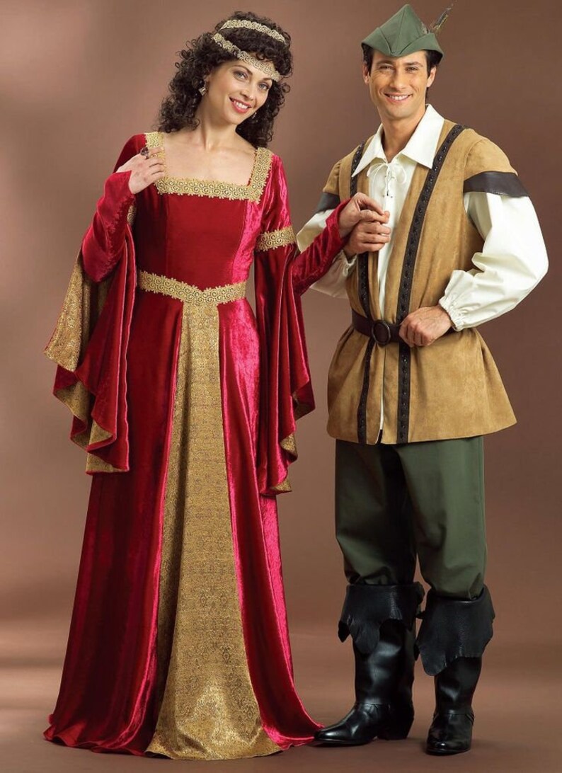 May include: A couple dressed in medieval costumes. The woman is wearing a red velvet gown with gold trim and a gold crown. The man is wearing a brown tunic with a green hat and brown trousers.