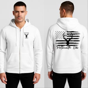 May include: White zip-up hoodie with a black graphic on the front and back. The front features a deer head logo with "Portsmouth, NH" and "Lodge 97". The back displays a deer head silhouette over a distressed American flag design with "Portsmouth Elks" text.