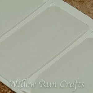 May include: Four clear plastic pockets on a white sheet with the text "Willow Run Crafts" printed at the bottom.