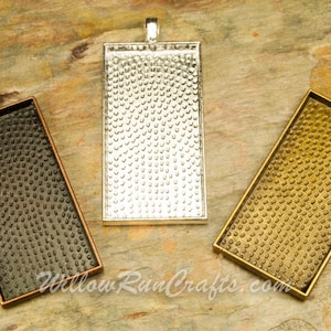 May include: Three rectangular pendant trays with a textured surface. The trays are silver, copper, and gold.