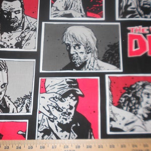 May include: Black fabric featuring comic book panels with zombie illustrations in black, white, and gray, set against red and gray backgrounds. The words "THE WALKING DEAD" are in red and white.