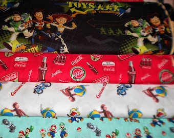 Character Fabrics #22 Toy Story, Curious George, Coke, Nintendo, Sold INDIVIDUALLY not as a group, by the Half Yard