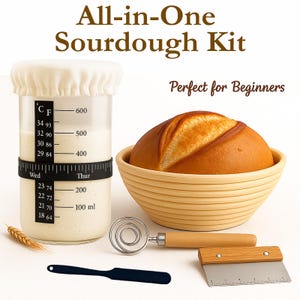 May include: An all-in-one sourdough kit featuring a glass jar with a temperature scale and day-of-the-week band, a round proofing basket with a loaf of bread, a metal dough whisk with a wooden handle, a black spatula, and a metal dough scraper.