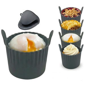May include: A dark grey silicone food mould with a poached egg inside, and a matching oven mitt. The image also shows the mould filled with other foods, including a dessert with whipped cream, a dish with a meat and potato topping, and a dish with a fruit crumble.