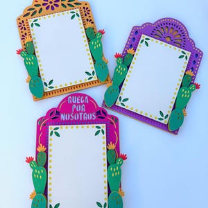 May include: Three colorful, decorative frames with cactus and floral designs. The frames are in shades of orange, purple, and pink, each with a white rectangular space for text. The bottom frame has the text "RUEGA POR NOSOTROS".