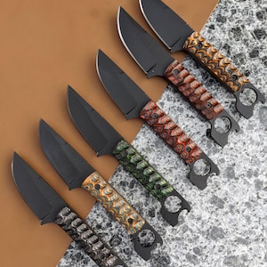 May include: Six black-handled knives with different colored, patterned handles. The handles are made of wood and have a unique, textured design. The knives have a black blade and a small hole in the handle.