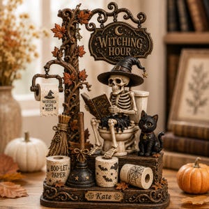 May include: A decorative figurine featuring a skeleton wearing a witch hat, sitting on a toilet and reading a book titled Spells Potions. The display includes a sign reading Witching Hour, a black cat, toilet paper rolls, and a plunger.