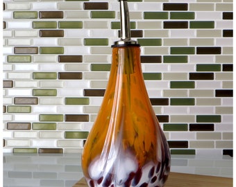 Hand blown glass olive oil bottle in saffron orange, white and dark red