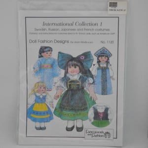 May include: A packet displaying illustrations of doll costumes from different cultures, including Swedish, Russian, Japanese, and French designs. The packet is labelled "International Collection 1" and includes the text "Doll Fashion Designs by Joan Hinds".
