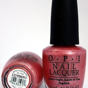 May include: A bottle of O.P.I. nail lacquer in the shade "Royal Flush Blush". The bottle is 0.5 fl oz (15 ml) and has a black cap. The label is pink and has the O.P.I. logo, the name of the shade, and the product description in English, French, Spanish, and German.