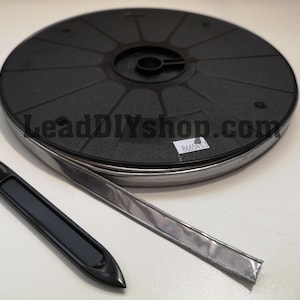 May include: A black and silver lead strip spool with a black plastic handle and a silver metal strip. The text "LeadDIYshop.com" is visible on the spool.