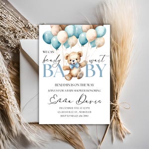 May include: A baby shower invitation with a blue and brown color scheme. The invitation features a teddy bear holding balloons and the text "We can barely wait BABY". The invitation also includes the name "Benjamin" and the text "Join us for a baby shower honoring Emma Davis".