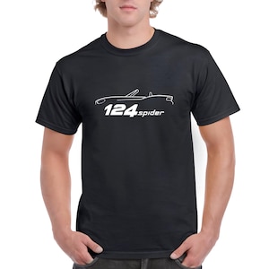 May include: Black t-shirt featuring a white outline of a Fiat 124 Spider and the text "124 spider".