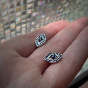 Sterling Silver Evil Eye Stud Earrings w/ clear and blue cubic zirconia and rhodium plating
